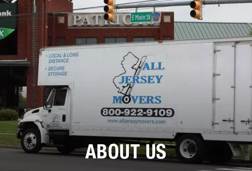 A white moving truck standing in the street