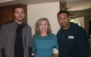 Two team members of All Jersey Movers with client