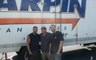The client is standing with a couple of men from All Jersey Movers