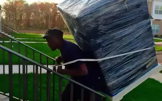 Team member of All Jersey Movers carrying goods